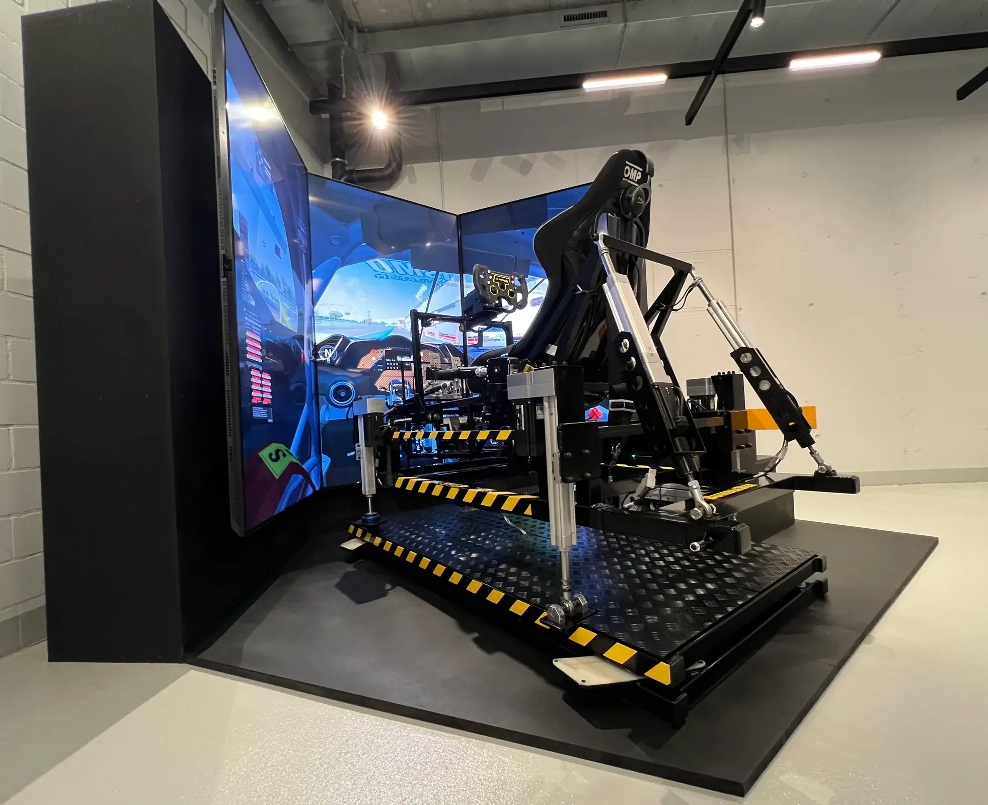The finished full-motion racing simulator in front of its curved screens