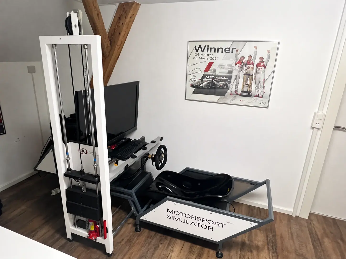 Leg press training device next to a motorsport simulator