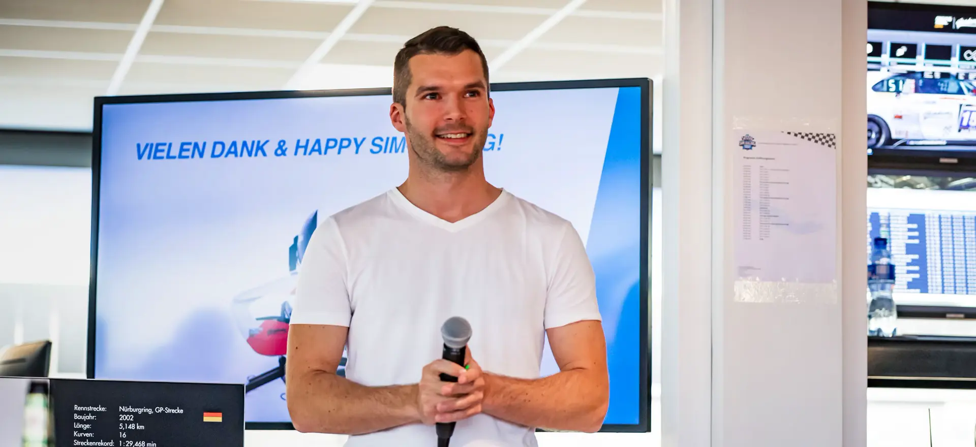 Yannick Mettler speaking with a microphone in front of a presentation screen